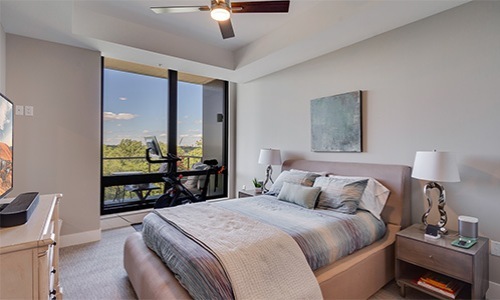Beautiful living spaces with natural lighting bedroom with bed lamps and large windows