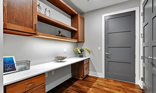 Love where you live workspace area with desk shelves and doors