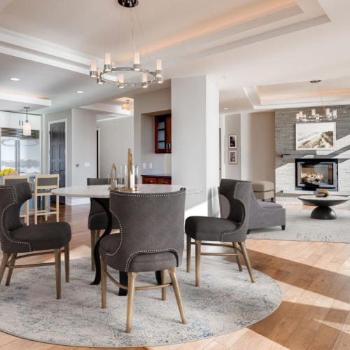 Relax and unwind in stylish living spaces a large living room with a fireplace and dining table with chairs