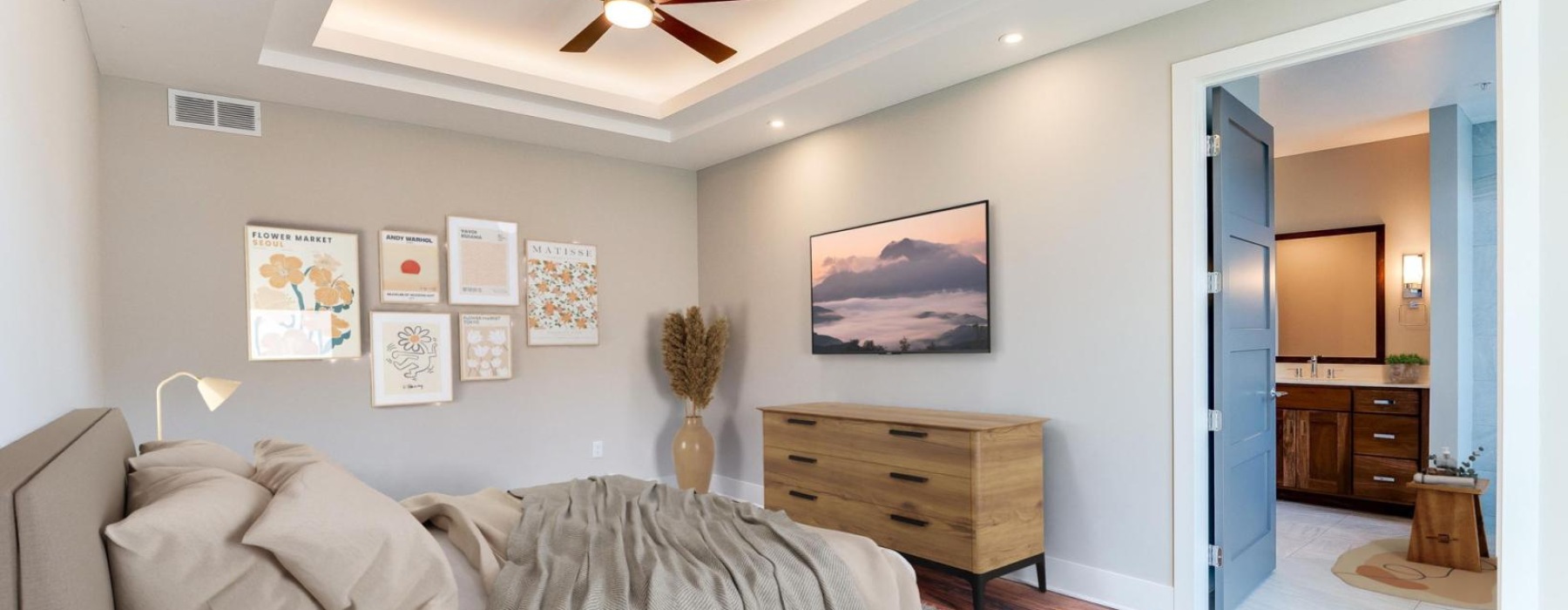 a bedroom with a tv bed and a fan