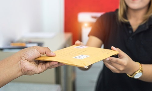 Love where you live someone handing a piece of mail to someone