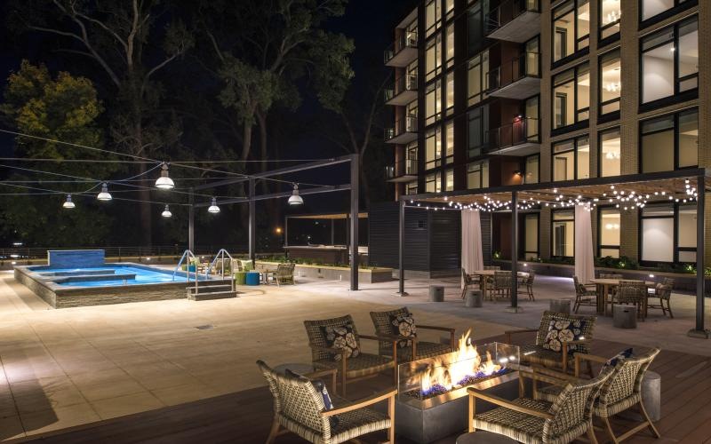 a pool and chairs outside a building
